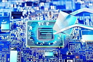 Technician plug in CPU microprocessor to motherboard socket.