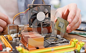 Technician plug in microprocessor to motherboard