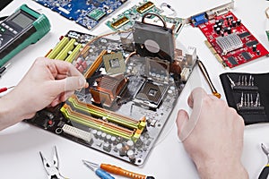 Technician plug in microprocessor to motherboard