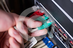Technician plugging ethernet in a rack mounted server