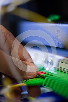 Technician plugging patch cable in a rack mounted server