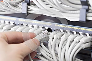 It technician plugs in network cable