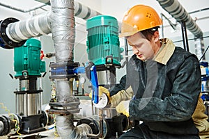 Technician plumber of heating system in boiler room