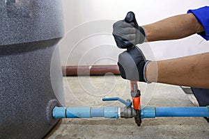 Technician plumber using a wrench to repair a water pump pipe. Concept of maintenance, fix water plumbing leaks drop or house