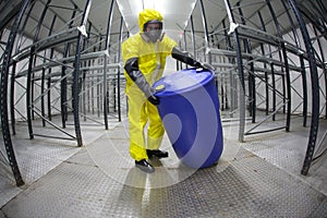 Technician in protective uniform with barrel