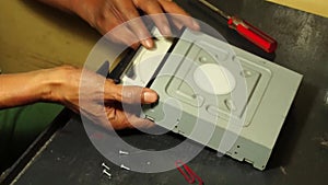 Technician pull out the carrier of DVD Optical Drive