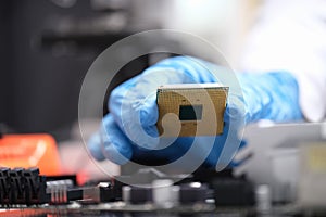 Technician puts processor on computer motherboard socket