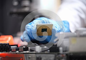 Technician puts processor on computer motherboard socket