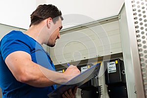 Technician reading the electricity meter photo