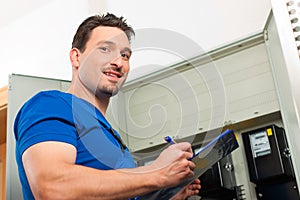 Technician reading the electricity meter