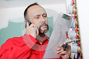 Technician reading water meter to check consumption