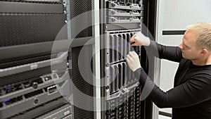 IT technician removes harddrive from blade server in datacenter