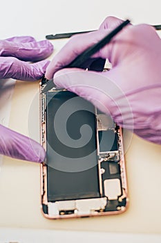 Technician repair faulty mobile phone in electronic smartphone t