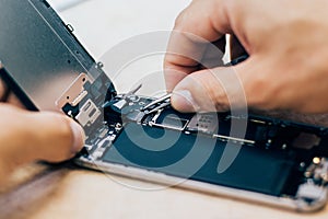 Technician repair faulty mobile phone in electronic smartphone t