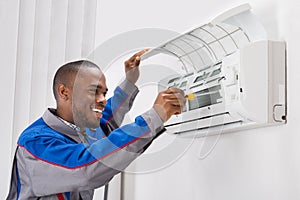 Technician Repairing Air Conditioner