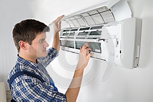 Technician Repairing Air Conditioner