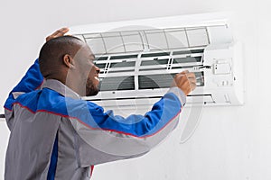 Technician Repairing Air Conditioner