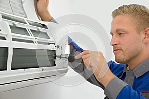 Technician repairing air conditioner