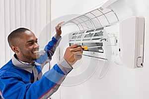 Technician Repairing Air Conditioner