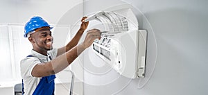 Technician Repairing Air Conditioner photo