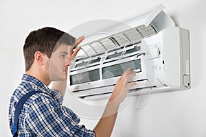 Technician Repairing Air Conditioner