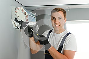 Technician repairing air conditioner on the wall