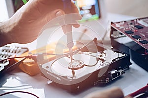 Technician repairing broken hard disk drive