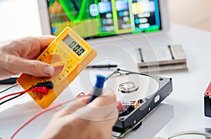 Technician repairing broken hard disk drive