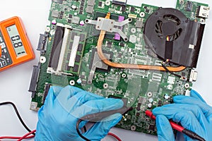 IT technician repairing broken laptop computer