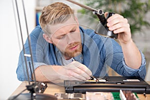 it technician repairing broken laptop notebook computer