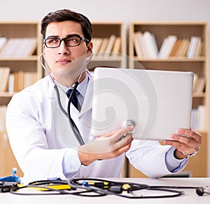 IT technician repairing broken laptop notebook computer