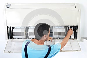 Technician repairing and checking air conditioner