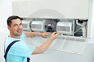 Technician repairing and checking air conditioner