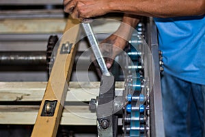 The technician repairing conveyor belt in factory.