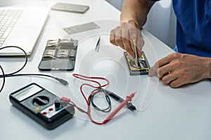 Technician repairing defective phone