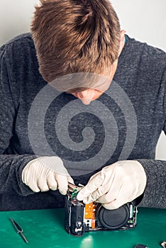 Technician repairing digital camera