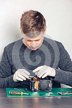 Technician repairing digital camera