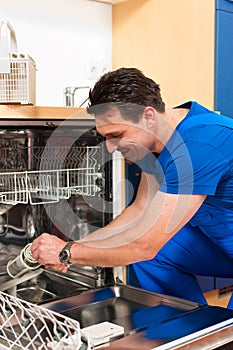 Technician repairing the dishwasher