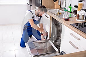 Technician Repairing Dishwasher