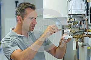 Technician repairing electric boiler