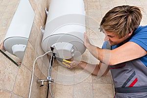 Technician Repairing Electric Boiler