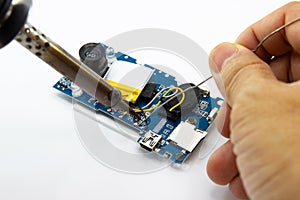 Technician repairing electronic of the circuit board by soldering Irons