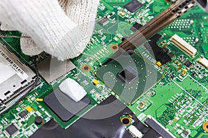 Technician repairing electronic of the computer`s circuit board by soldering Irons