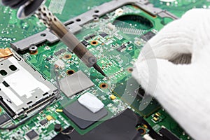 Technician repairing electronic of the computer`s circuit board by soldering Irons