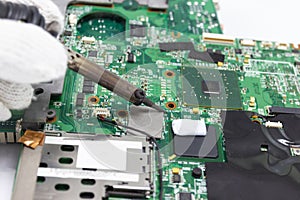 Technician repairing electronic of the computer`s circuit board by soldering Irons