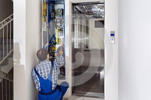 Technician Repairing Elevator