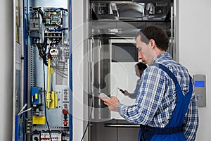 Technician Repairing Elevator