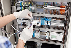 Technician repairing fusebox