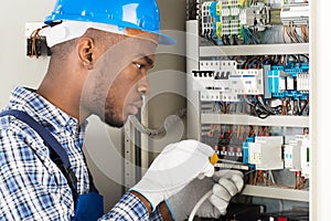 Technician Repairing Fusebox With Screwdriver