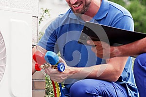 Technician Repairing Heat Pump Air Conditioning